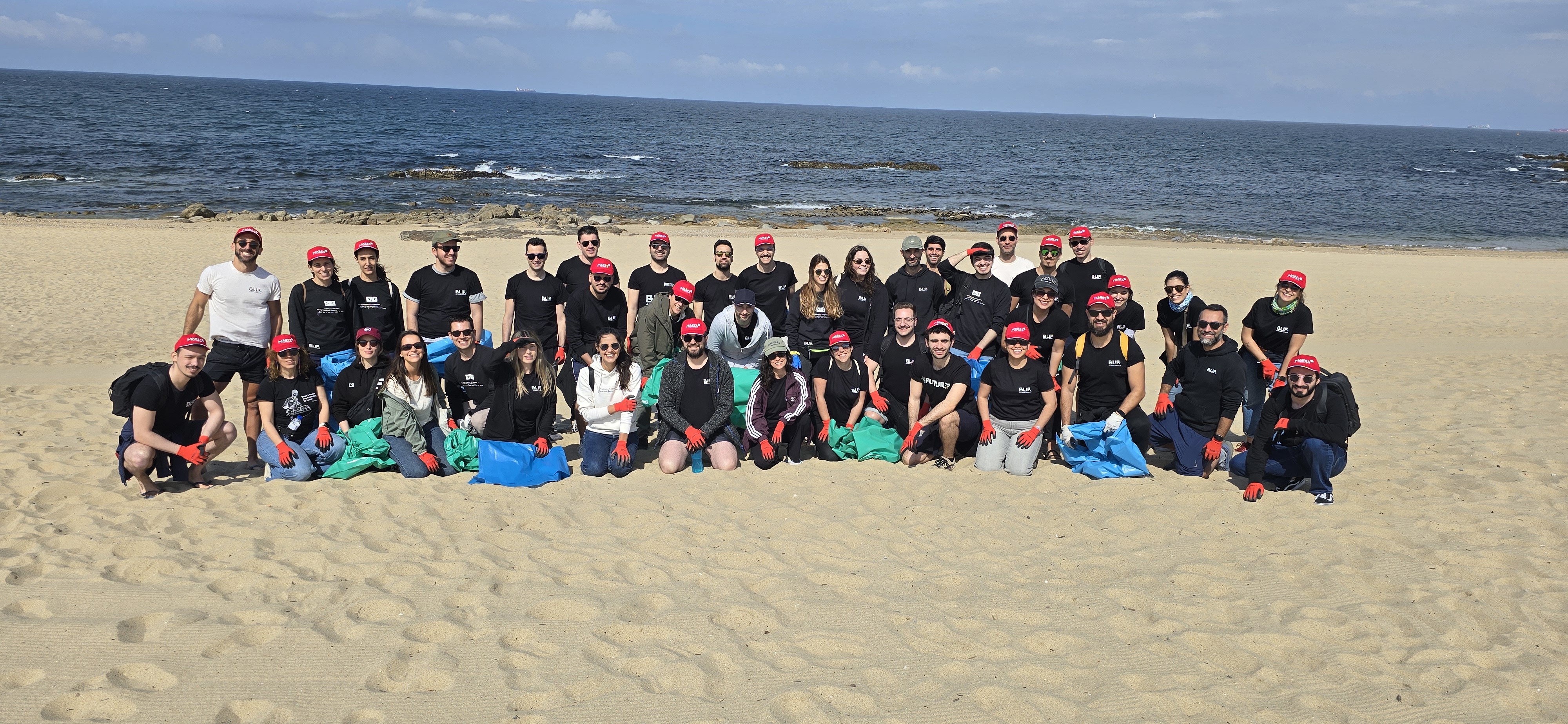 Grupo De Voluntários A Recolher Lixo Durante Uma Limpeza De Praia